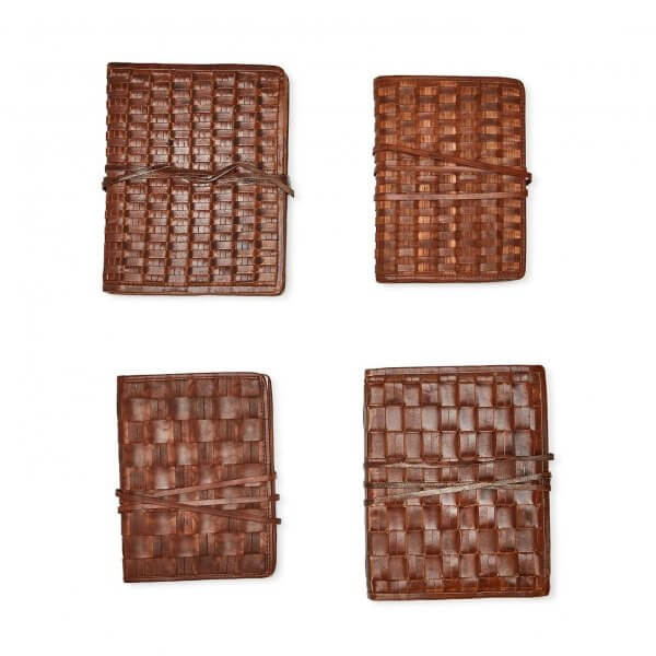 Four brown woven leather journals, treasures from Memphis, arranged in a grid pattern.
